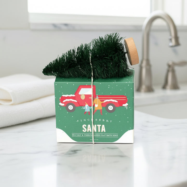 Christmas-themed product packaging with a red truck and tinsel on a white background